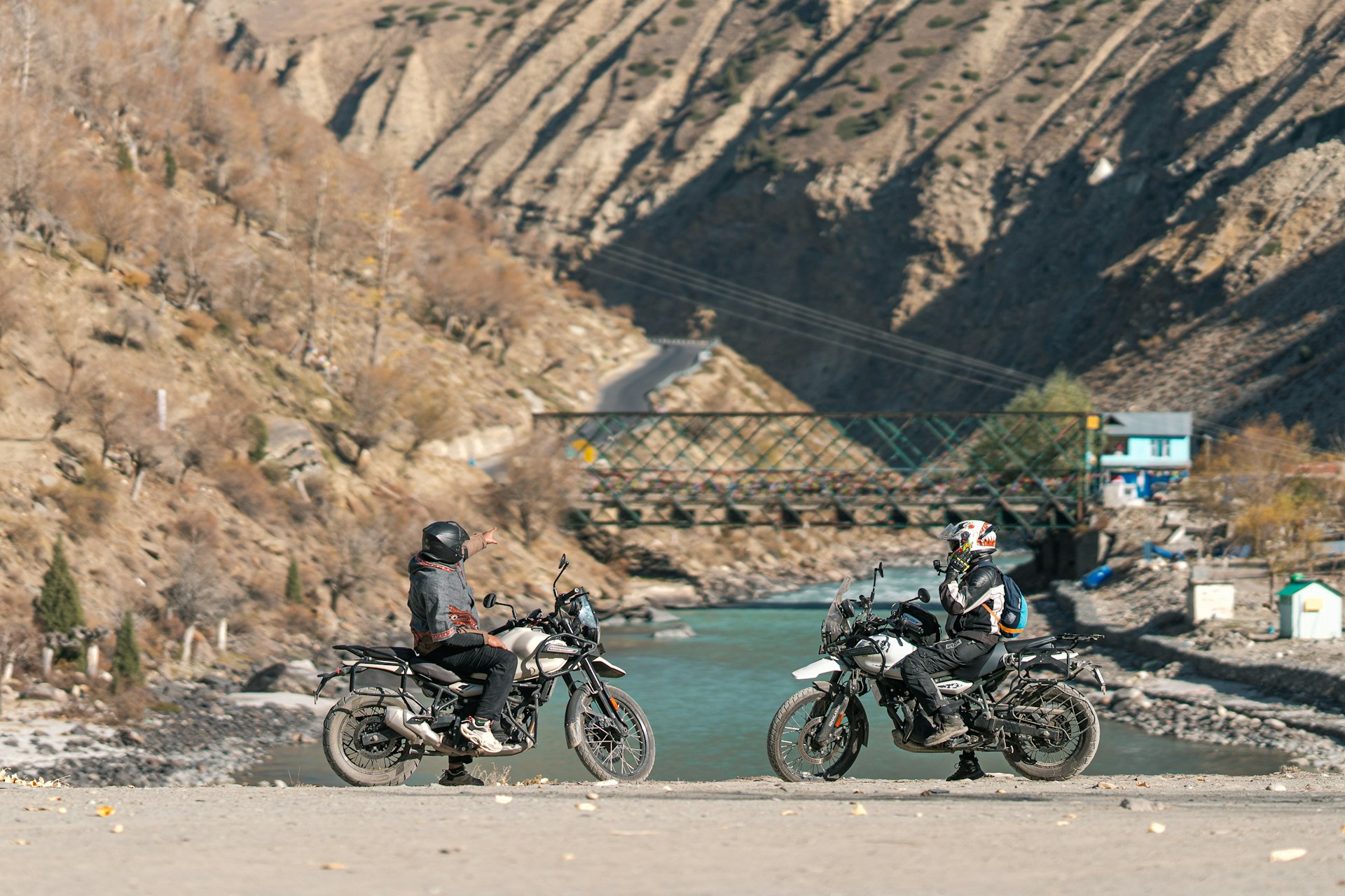 A group of motorcycles parked next to a river